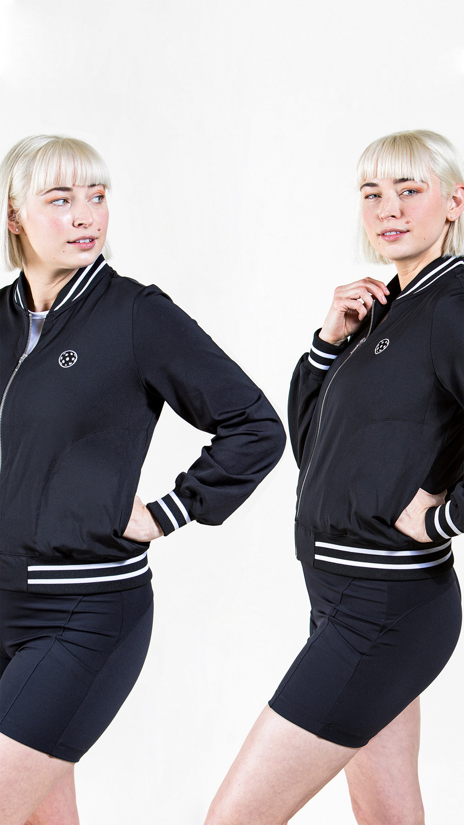 Model wearing Saltie Rose Black Bomber Pickleball Jacket with Pickleball logo and black pickleball shorts with 5" inseams.