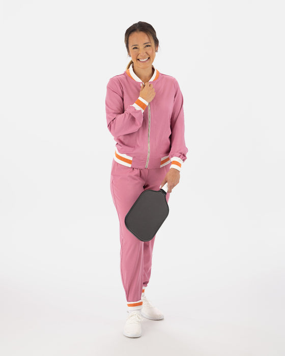 Saltie Rose Pink Bomber with orange and white stripe at waist, collar, and wrists, paired with Pink joggers with orange and white stripe band at ankles.
