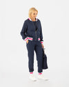 Saltie Rose Navy Bomber with pink and white stripe at waist, collar, and wrists, paired with Navy joggers with pink and white stripe band at ankles.
