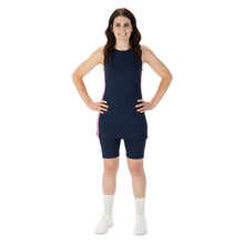  Midnight blue racerback tunic with pink and white striped side panels, blue pickleball shorts with nine inch inseam