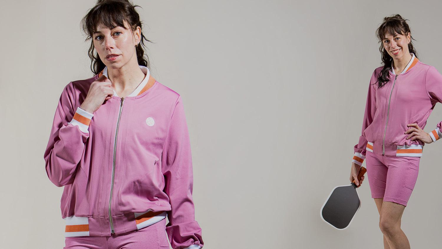 Woman pickleball player wearing saltie rose Rose colored bomber jacket and matching shorts.
