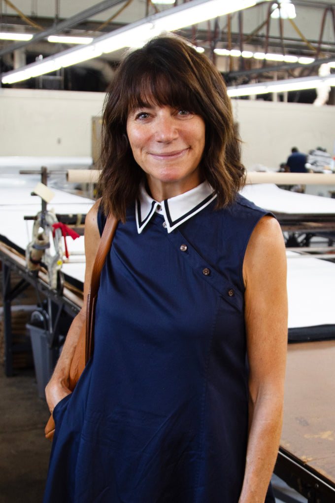  Terrie Rose, designer and ceo of Saltie Rose smiling at clothing manufacturing warehouse