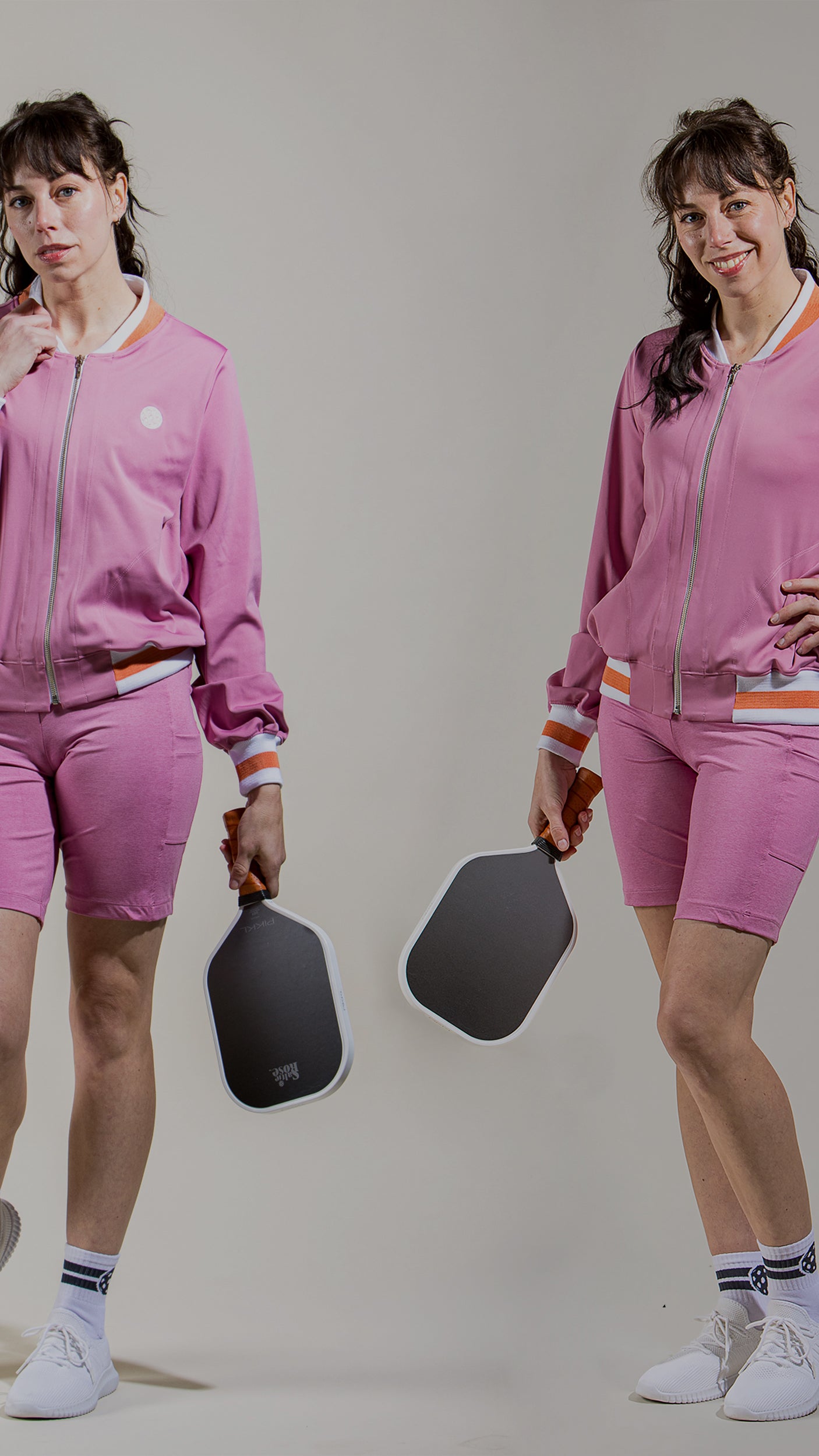 Woman pickleball player wearing saltie rose Rose colored bomber jacket and matching shorts.